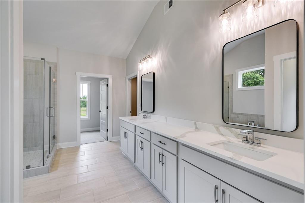 662 Lake Cir Road Buchanan, GA 30113 - Photo 49 of 62 a spacious bathroom with a double vanity sink double and mirror