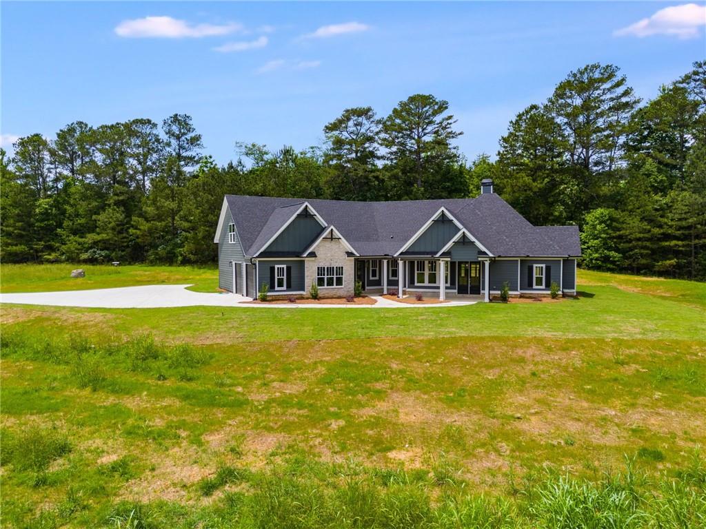662 Lake Cir Road Buchanan, GA 30113 - Photo 5 of 62 a front view of a house with a garden