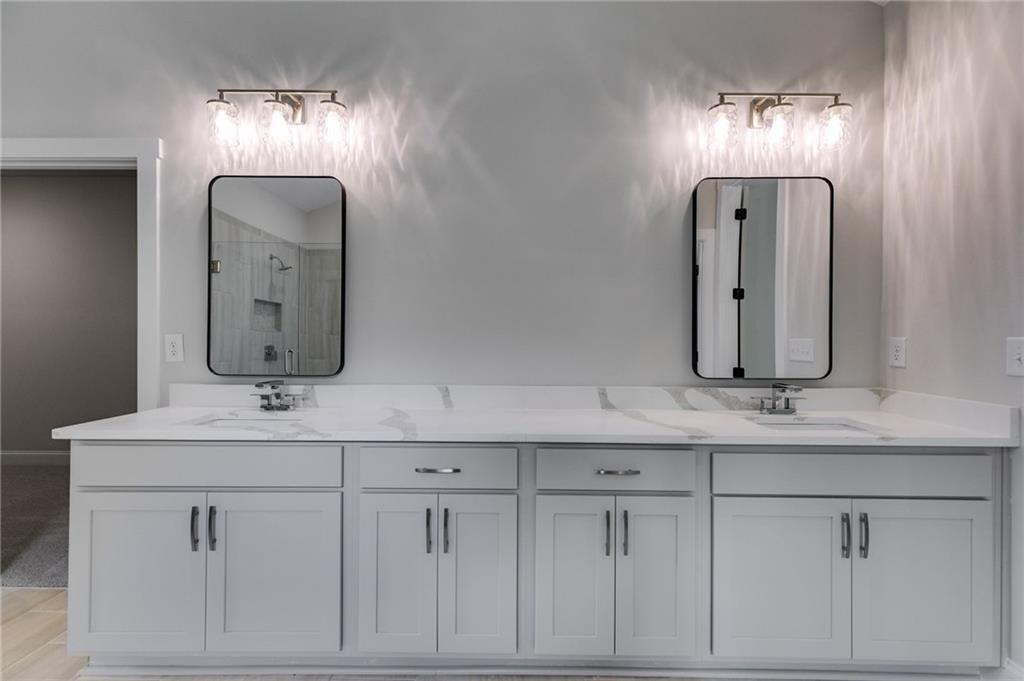 662 Lake Cir Road Buchanan, GA 30113 - Photo 51 of 62 a bathroom with double sink and a mirror