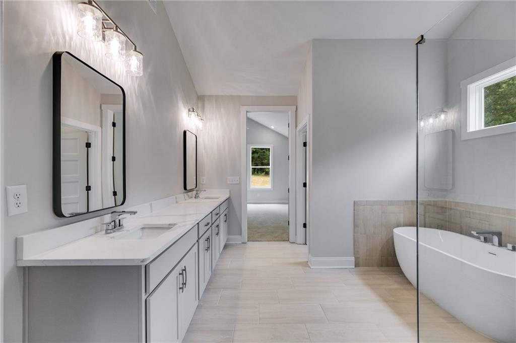 662 Lake Cir Road Buchanan, GA 30113 - Photo 55 of 62 a bathroom with a double vanity sink mirror double and bathtub