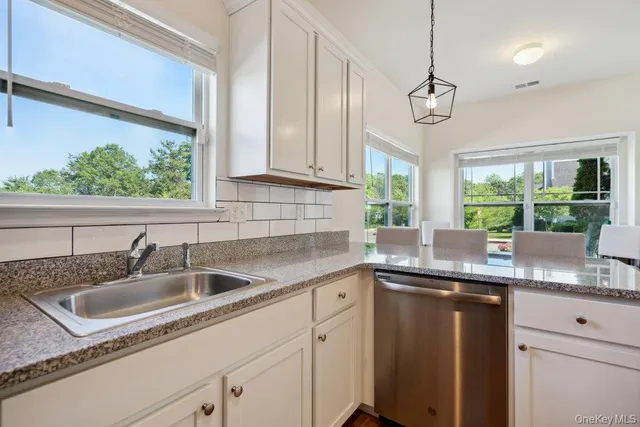 a kitchen with granite countertop a sink and a window