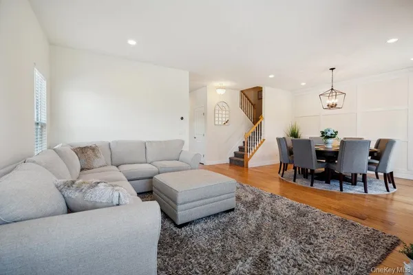 a view of a dining room with furniture wooden floor and a chandelier