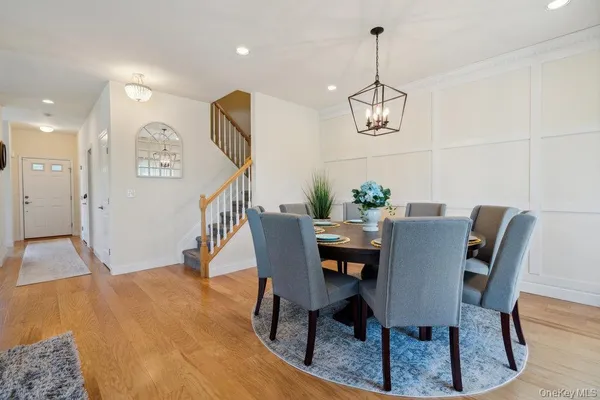 a dining room with furniture and a chandelier
