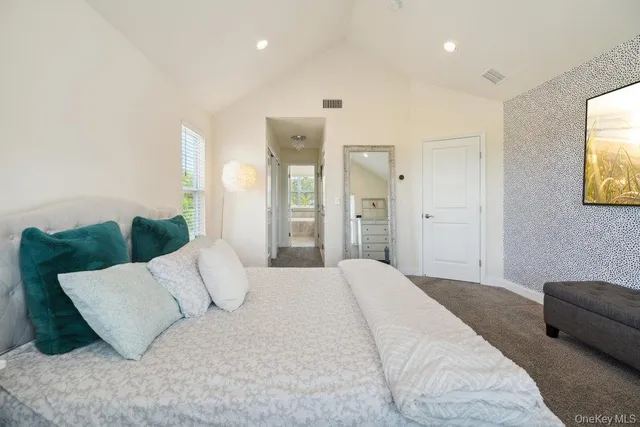 a spacious bathroom with a granite countertop tub a sink and a large window