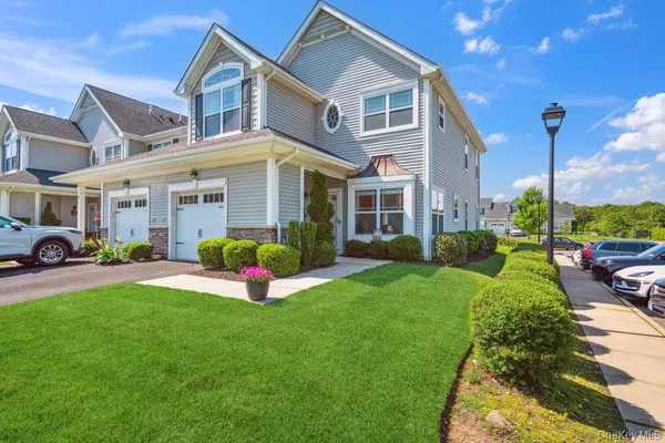 a view of a house with a yard and plants