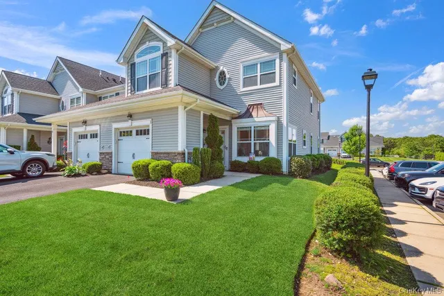 a view of a house with a yard and plants