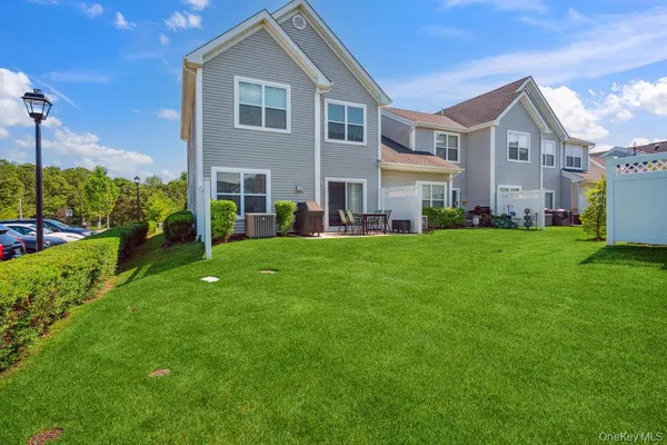 a view of a house with backyard sitting area and garden