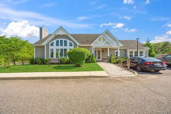 a living room with furniture a rug and a chandelier
