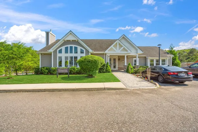 a living room with furniture a rug and a chandelier
