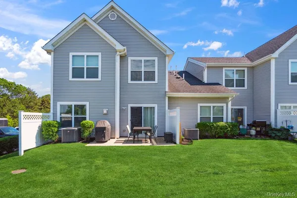 a front view of house with a garden and patio