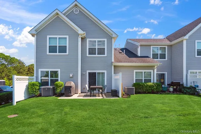 a front view of house with a garden and patio