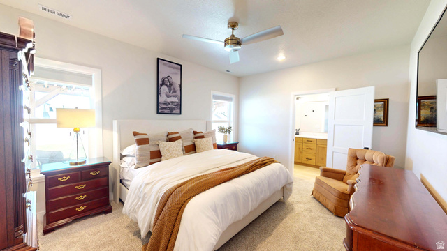 1127 4240 North Enoch, UT 84721 - Photo 18 of 56 Master Bedroom with ensuite bath, light carpet, and ceiling fan