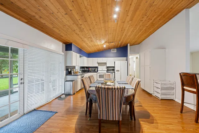 a dining room with furniture and wooden floor
