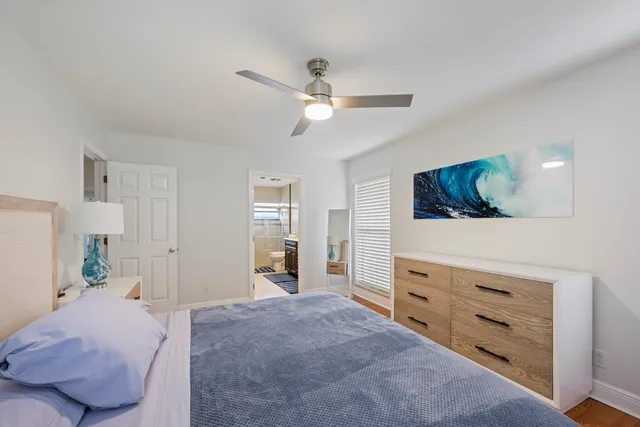 a bed room with a bed and a dresser