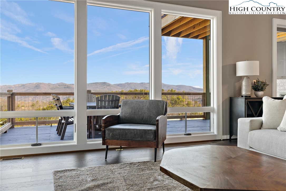 150 Calico Court Boone, NC 28607 - Photo 12 of 50 a living room with furniture and a floor to ceiling window