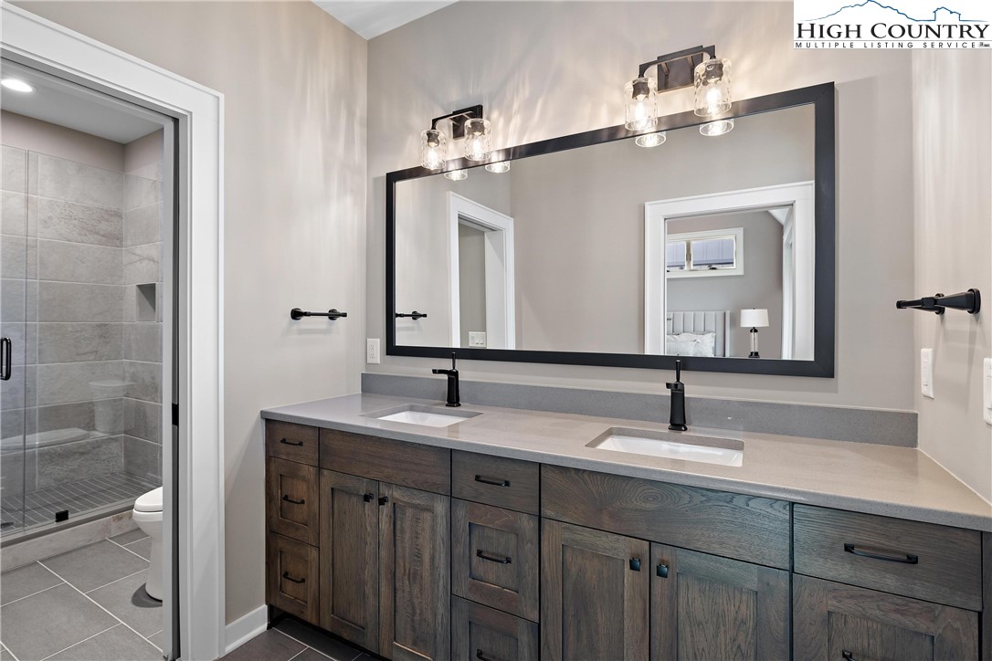 150 Calico Court Boone, NC 28607 - Photo 23 of 50 a bathroom with a double vanity sink and mirror