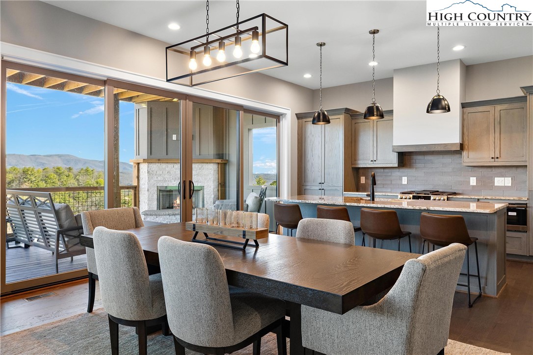 150 Calico Court Boone, NC 28607 - Photo 4 of 50 a kitchen with a table chairs stove and cabinets