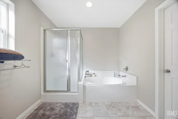 a bedroom with a bed and a flat tv screen