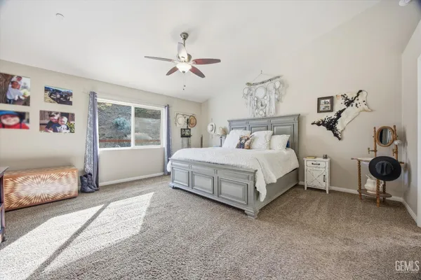 a large bathroom with a granite countertop double vanity sink a mirror and a toilet