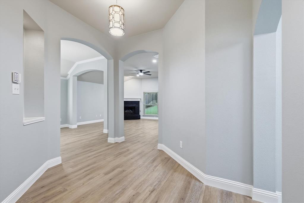 2616 Hollow Ridge Drive Denton, TX 76210 - Photo 8 of 31 Entryway featuring wood-finish flooring, light grey walls, and a decorative pendant light fixture