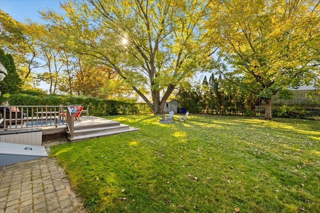 261 Emmett Street Fall River, MA 02721 - Photo 12 of 40 a view of yard with swimming pool and trees in the background