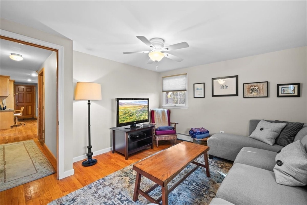 261 Emmett Street Fall River, MA 02721 - Photo 21 of 40 a living room with furniture a flat screen tv and a table