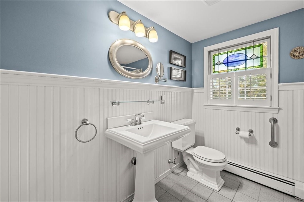 261 Emmett Street Fall River, MA 02721 - Photo 23 of 40 a bathroom with a toilet sink vanity and mirror