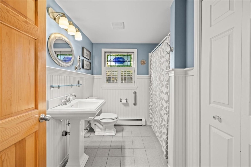 261 Emmett Street Fall River, MA 02721 - Photo 24 of 40 a bathroom with a sink a toilet and a mirror