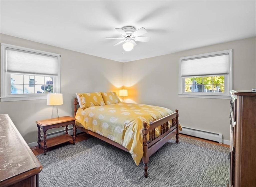 261 Emmett Street Fall River, MA 02721 - Photo 25 of 40 a bedroom with a bed and a chandelier