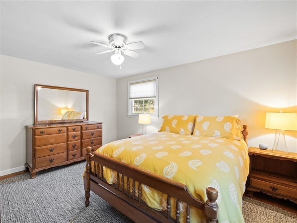 261 Emmett Street Fall River, MA 02721 - Photo 27 of 40 a bedroom with a bed and a chandelier