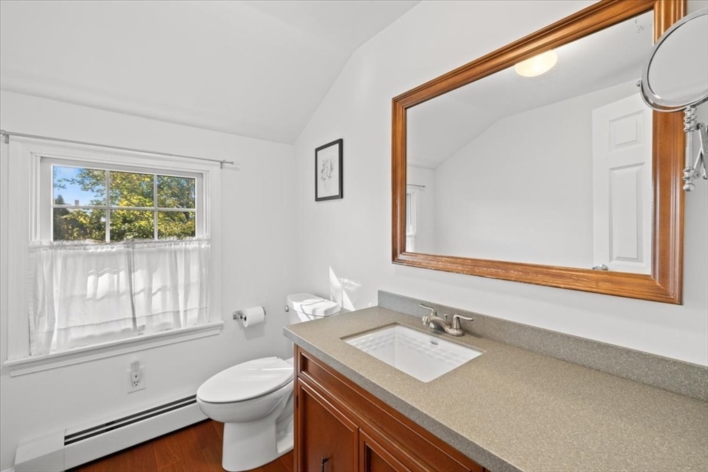 261 Emmett Street Fall River, MA 02721 - Photo 31 of 40 a bathroom with a sink a toilet and a window