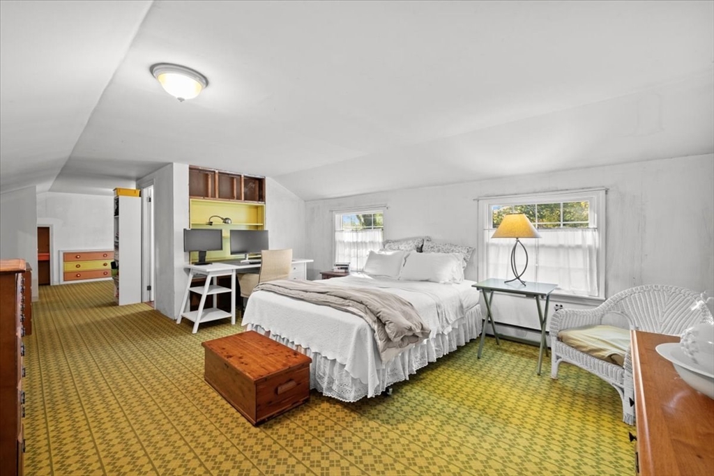 261 Emmett Street Fall River, MA 02721 - Photo 34 of 40 a bedroom with a bed and a table in it