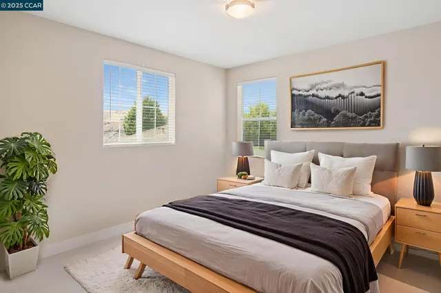 a bedroom with a bed and a painting on the wall