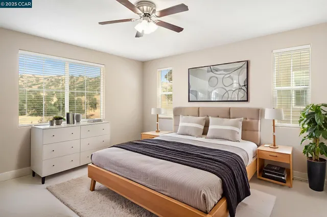 a bedroom with a large bed and a window