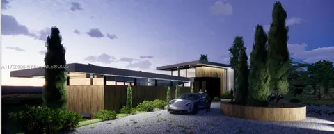 a front view of a house with garden view and seating space