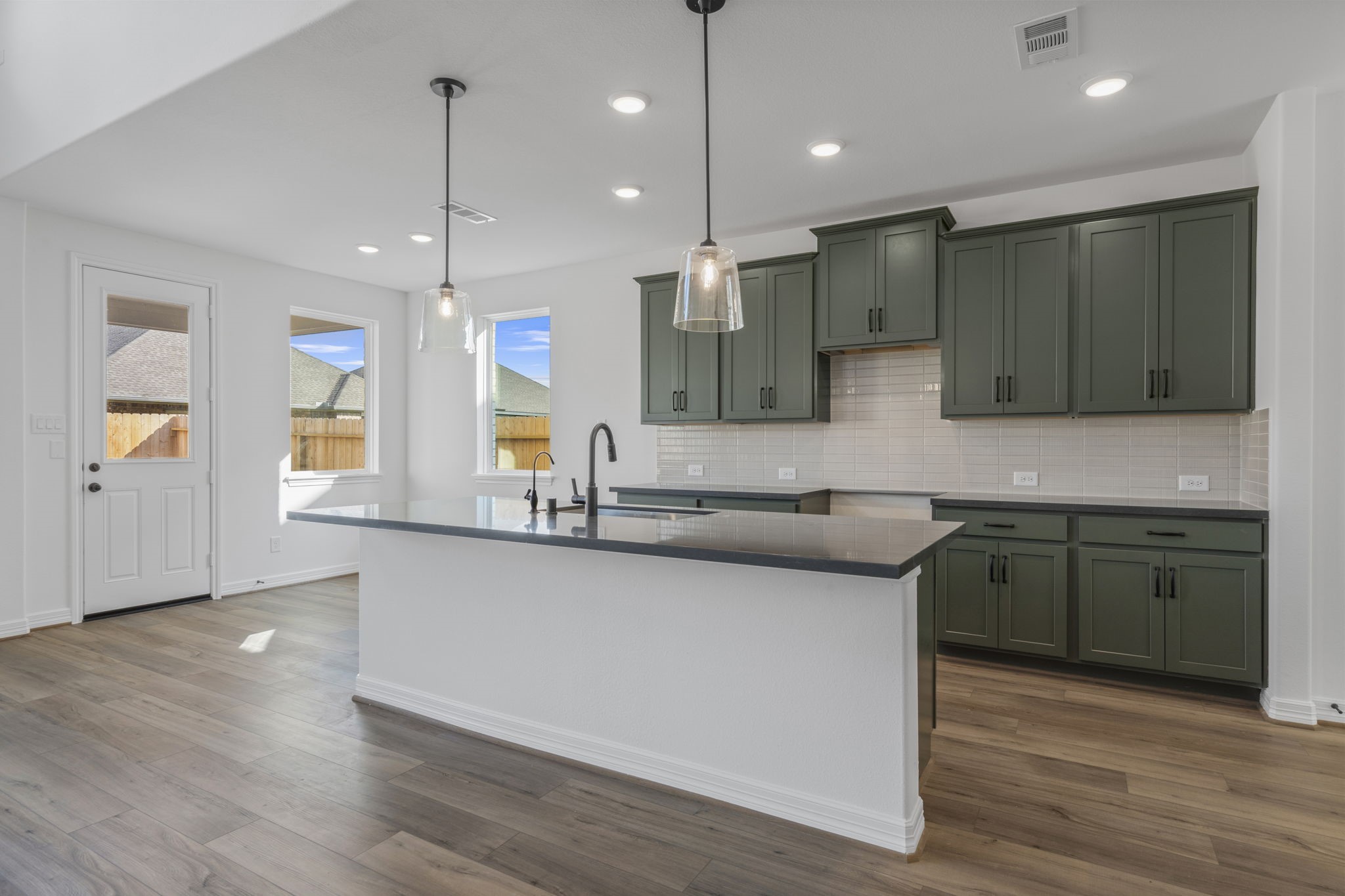 7822 Jasper Meadows Way Angleton, TX 77515 - Photo 9 of 33 a kitchen with stainless steel appliances granite countertop a sink a stove and a wooden floors