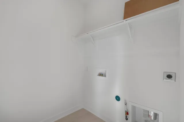 a kitchen with stainless steel appliances granite countertop a sink a stove and a wooden floors