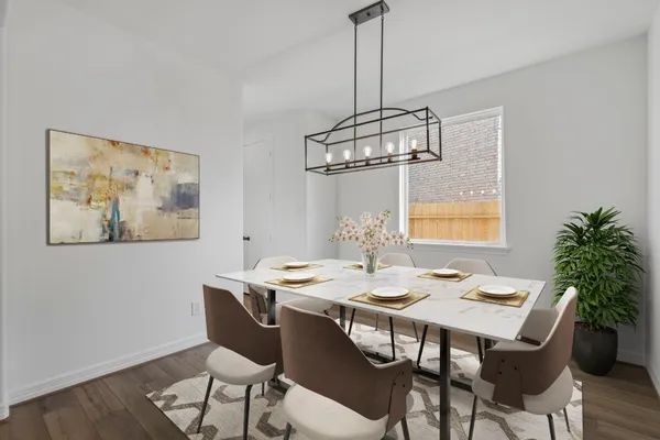 a view of a dining room furniture and wooden floor