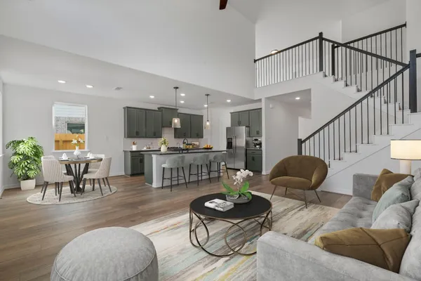 a living room with furniture kitchen view and a table