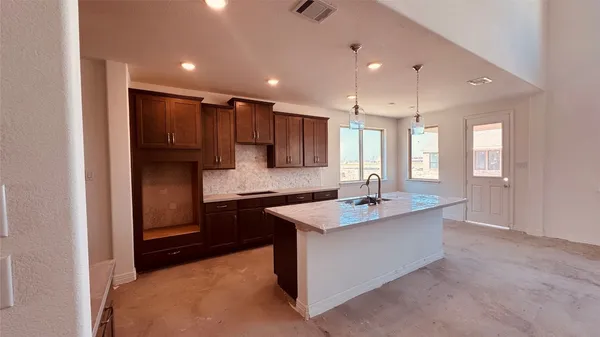 a view of empty room with window and wooden floor