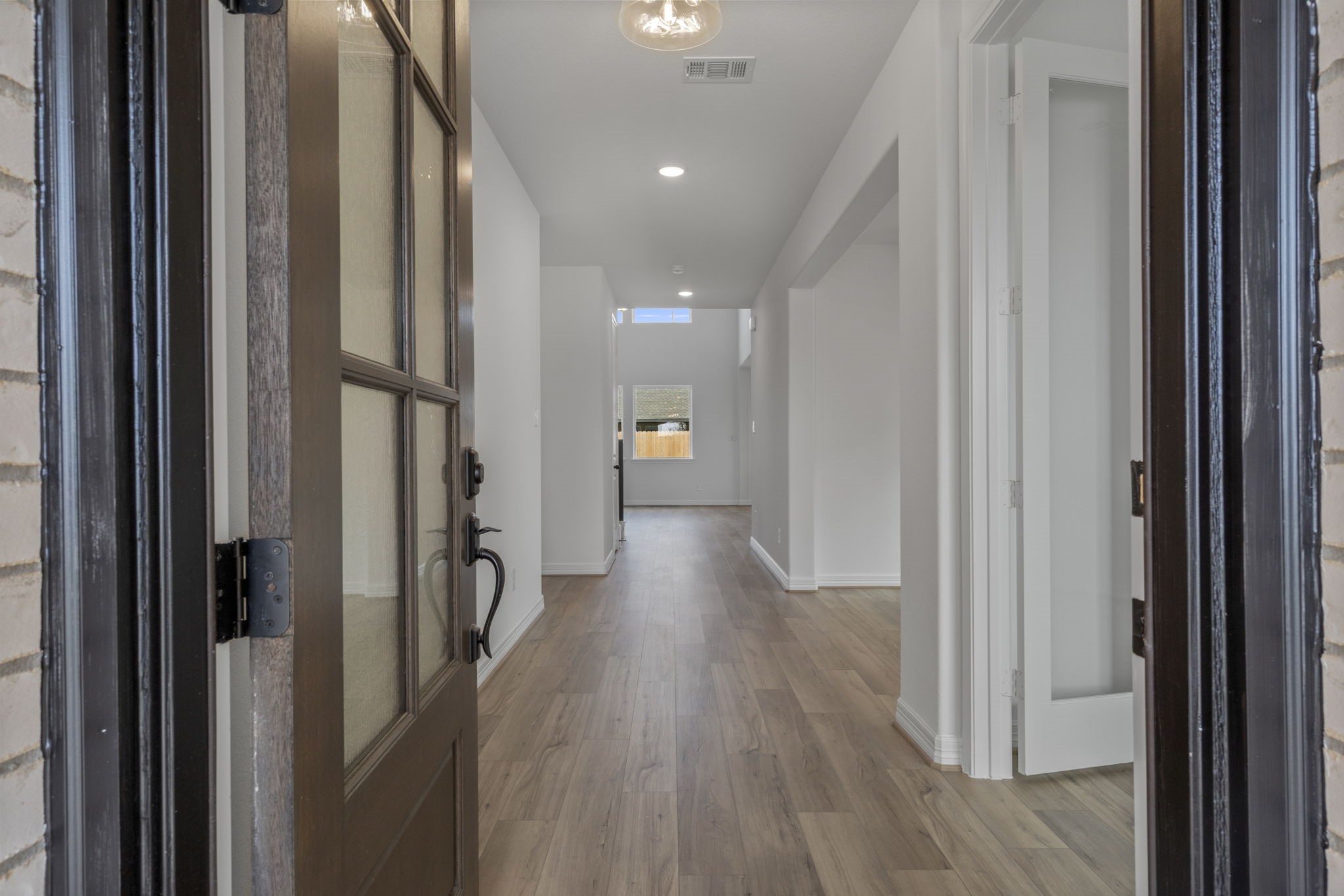7822 Jasper Meadows Way Angleton, TX 77515 - Photo 4 of 33 a view of a hallway with wooden floor and stairs