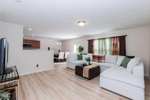 a living room with couches and a flat screen tv