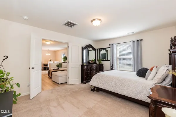 a bedroom with a bed and a couch