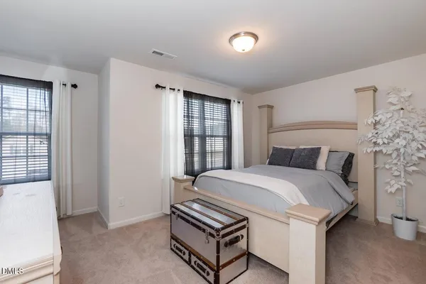 a bed room with a bed and a window