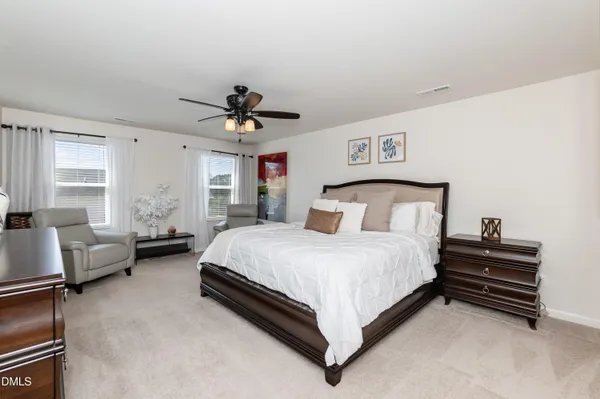 a bedroom with a bed couch and window