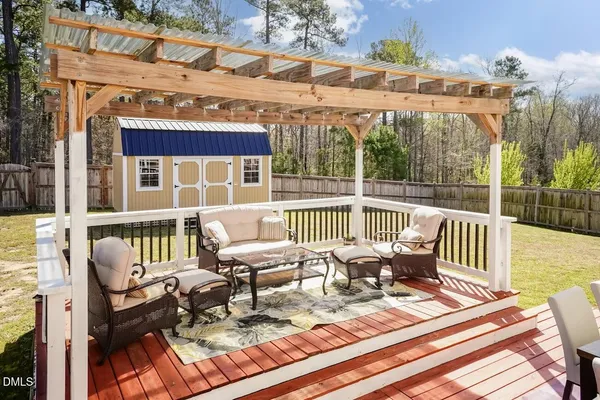 a view of a chair and table on the deck
