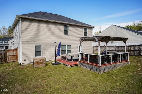 a view of a house with a backyard