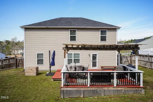 a view of a house with a wooden deck