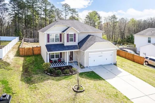 a aerial view of a house with a yard