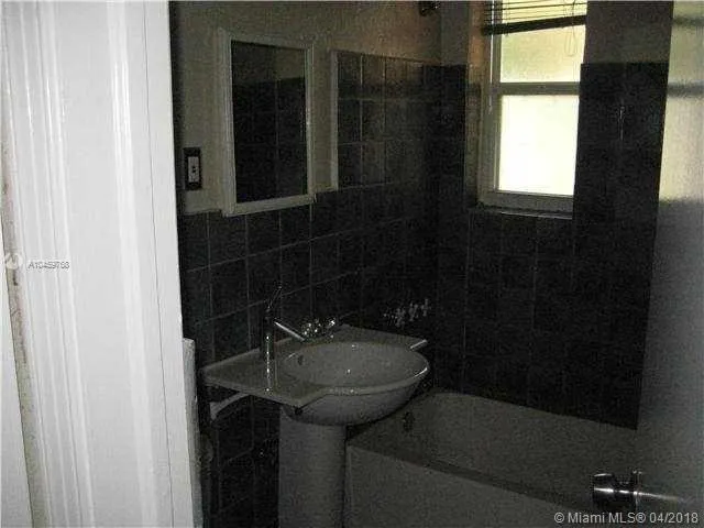a bathroom with a sink a toilet and a shower